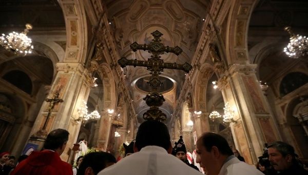 Members of the church hold a cross during a mass at the Santiago cathedral, in Santiago, Chile July 25, 2018.
