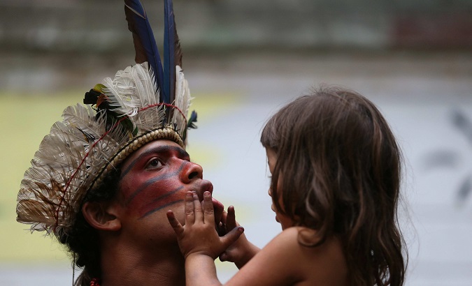 Guajajara man with his daughter during a 2013 protest in Rio de Janeiro.