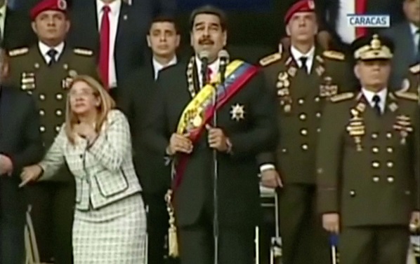 President Maduro (C) and his wife react as a drone is detonated during the National Armed Guard's anniversary event.