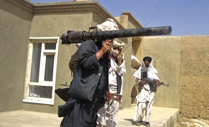 Taliban fighters in south Afghanistan pose with weapons.