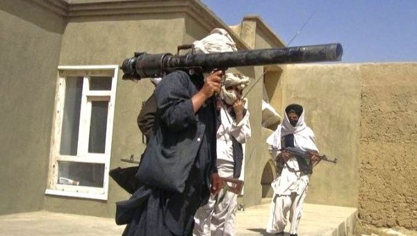 Taliban fighters in south Afghanistan pose with weapons. 