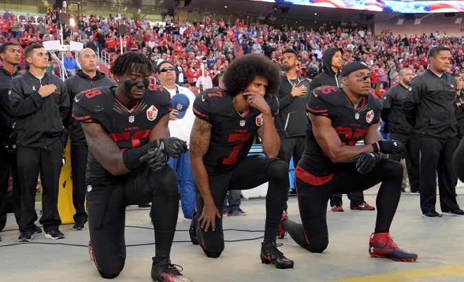 San Francisco 49ers outside linebacker Harold, quarterback Kaepernick and free safety Reid kneel in protest during the playing of the national anthem in 2016.