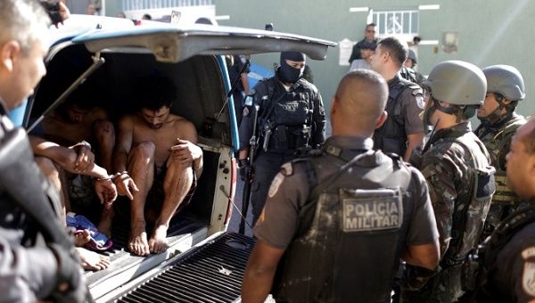 Brazilian Army soldiers arrest young men in Alemao slums complex in Rio de Janeiro, Brazil August 20, 2018