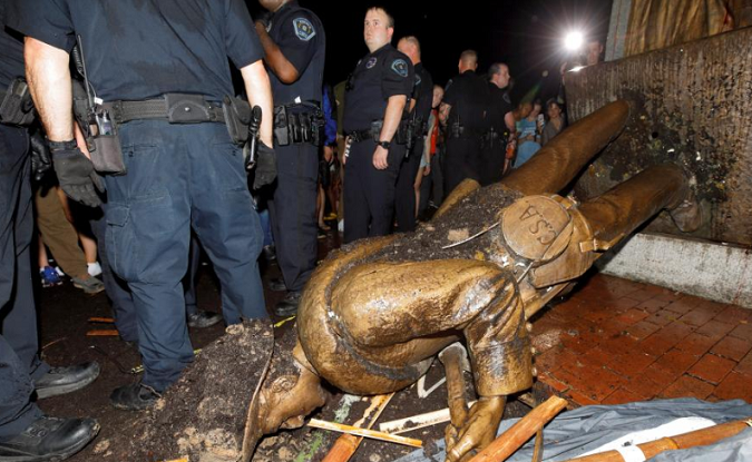 University of North Carolina police surround the toppled statue of a Confederate soldier on the school's campus after a demonstration for its removal in Chapel Hill, North Carolina, U.S. August 20, 2018.