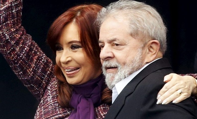 Cristina Fernadez de Kirchner attends an event alongside Luiz Inacio Lula da Silva.