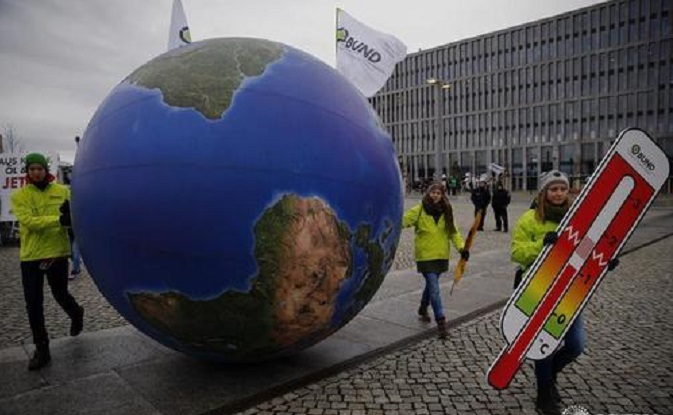 Protesters demonstrate during a rally held the day before the start of the Paris Climate Change Summit in Berlin, Germany, November 29,