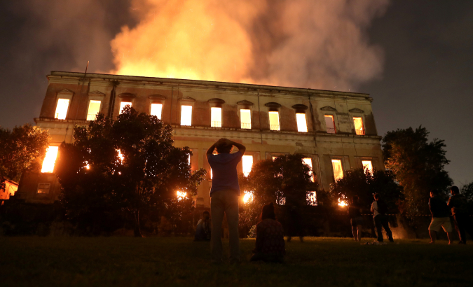 People watch as a fire burns at the National Museum of Brazil in Rio de Janeiro.