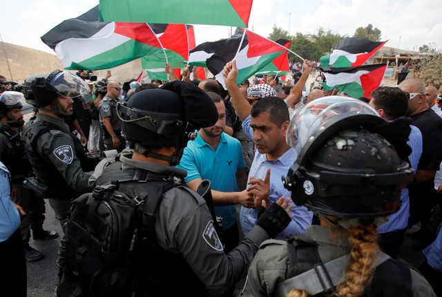 Palestinian demonstrator argues with Israeli border police during protest against planned demolition of Bedouin village Khan al-Ahmar, in the occupied West Bank.