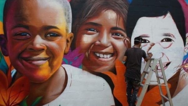 An artist paints a mural in La Paz, Bolivia.