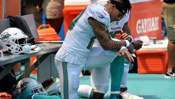 Miami Dolphins wide receiver Kenny Stills (left) and Dolphins wide receiver Albert Wilson (right) both kneel during the national anthem prior to a game against the Tennessee Titans at Hard Rock Stadium.