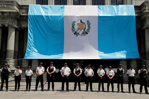 Police officers stand guard in front of the National Palace of Culture during a protest to demand the resignation of Guatemala's President Jimmy Morales in Guatemala City, Guatemala September 12, 2018.