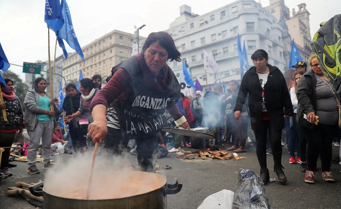 A woman prepares food at a soup kitchen during a demonstration against the government’s economic measures in Buenos Aires, Argentina Sept. 12, 2018.