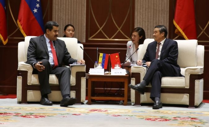 Venezuelan President Nicolas Maduro meets with Hu Huaibang, president of the Development Bank of China.
