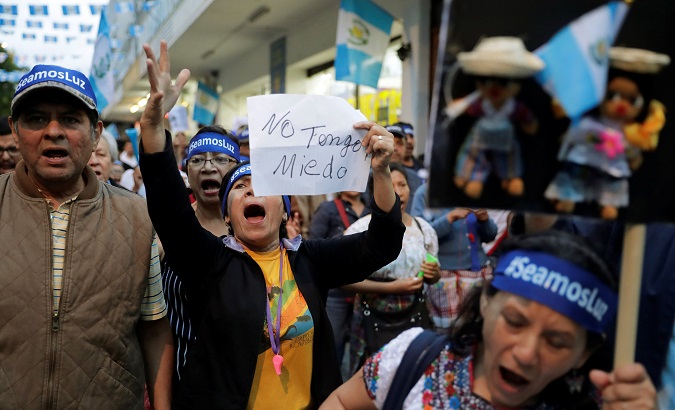 Guatemalans take part in Independence day protests against Morales. Sign reads 