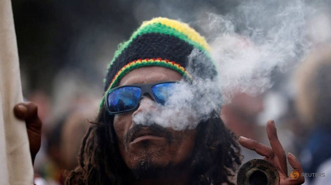 A man smokes marijuana, known locally as dagga, during a march calling for the legalization of cannabis in Cape Town, South Africa, May 6, 2017.
