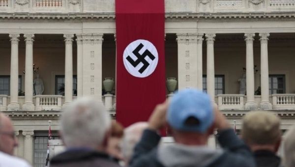 A Nazi swastika banner hangs on the facade of the Prefecture Palace in Nice which is being used as part of a movie set during the filming of a WWII film in the old city of Nice, France.