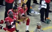 Colin Kaepernick and 49ers teammate, free safety Eric Reid, kneel during the playing of the national anthem before a Monday Night Football game.