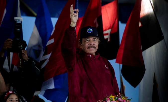 Nicaraguan President Daniel Ortega waves to his supporters during a march in Managua, Nicaragua Sept. 29,2018.