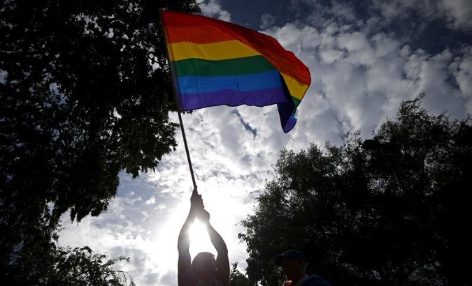 A man waves an LGBT equality rainbow flag at a celebration rally in West Hollywood, California, United States, Jun. 26, 2015.