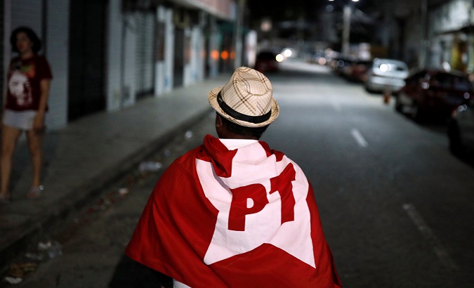 A supporter of Fernando Haddad, presidential candidate of Brazil's leftist Workers' Party (PT), walks in Fortaleza, Brazil Oct. 7, 2018.