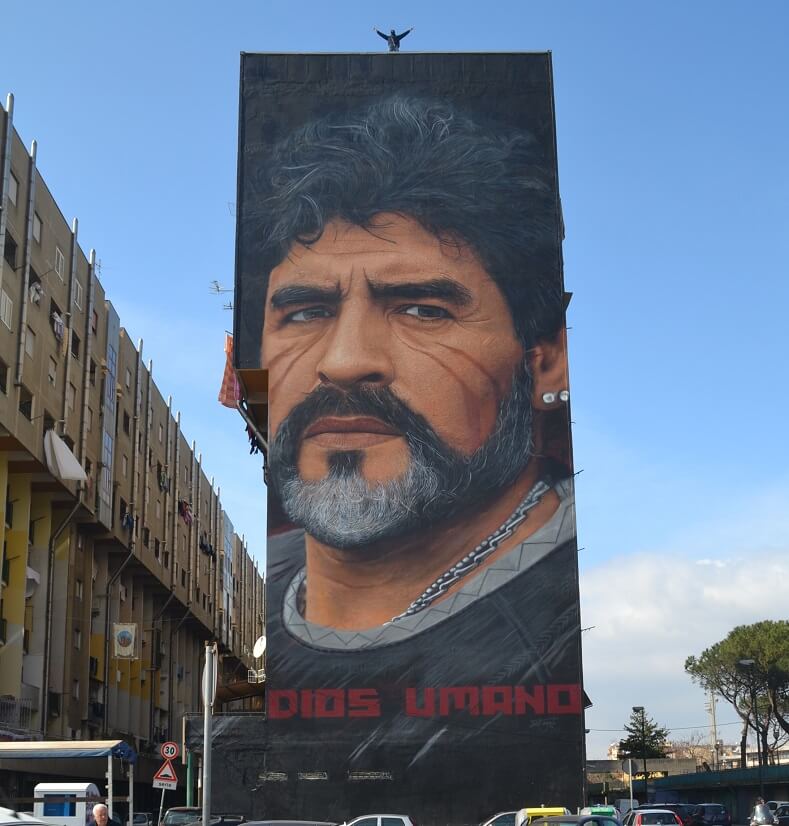 Diego Armando Maradona. All his images are marked by two red stripes. “They refer to African magic healing rituals, particularly to the procedure of scarification, initiation rite of the transition from childhood to adulthood that is linked to the symbolic moment of the entry of the individual into the tribe.”