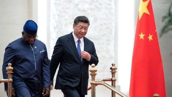 Sierra Leone President Julius Maada Bio (L), seen here with Chinese President Xi Jinping on Aug. 30, 2018, has reassessed several financial commitments.