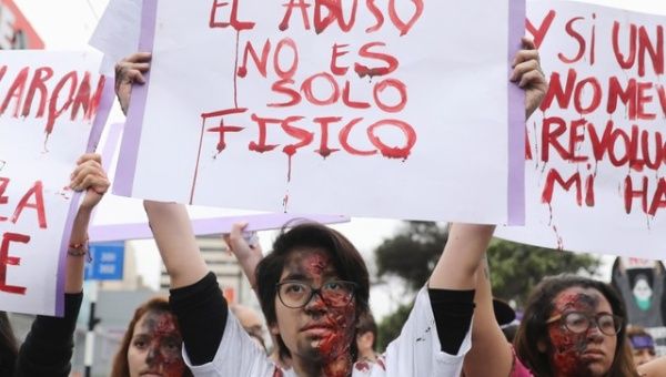 A demonstrator holds a sign saying 