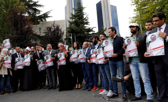 Human rights activists and friends of Saudi journalist Jamal Khashoggi hold his pictures during a protest outside the Saudi Consulate in Istanbul, Turkey Oct. 8, 2018.