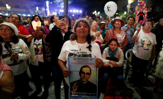 People watch the canonization ceremony for late Archbishop of San Salvador Oscar Arnulfo Romero at the Gerardo Barrios Square in El Salvador, Oct. 14, 2018.