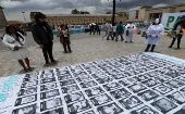 Fotografías de líderes sociales asesinados exhibidas como parte de una protesta, en septiembre pasado, en la Plaza de Bolívar en Bogotá.