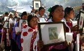Members of "Las Abejas" hold portraits of their relatives on the seventh anniversary of the Acteal Massacre. Dec. 22, 2004. Acteal, Chiapas, Mexico.