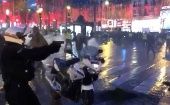 A police motorcycle officer pulls a gun during a demonstration of the "yellow vests" movement on Champs Elysees in Paris