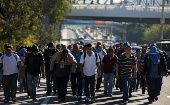 Thousands of migrants walking down the highway en route to the United States