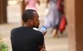 A man checks his mobile phone in Harare, Zimbabwe, Jan. 18, 2019.