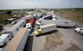 Trucks wait in a long queue for border customs control in Nuevo Laredo, Mexico, April 2, 2019.