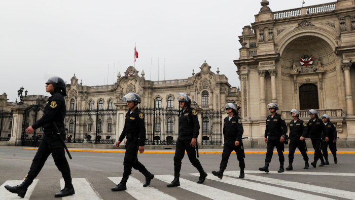 Miembros de una patrulla policial caminan cerca del palacio de gobierno en Lima, Perú.