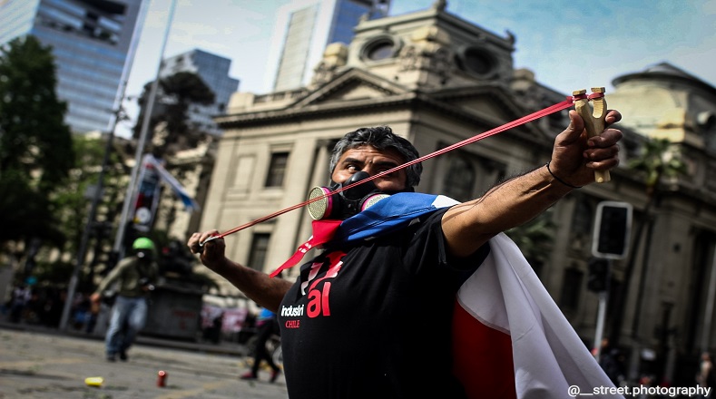 Fotografía tomada de un manifestante defendiéndose con una resortera (Santiago de Chile, 11 de noviembre de 2019).