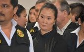 Opposition leader Keiko Fujimori is escorted by police officers in Lima, Peru, on Oct. 31, 2018.