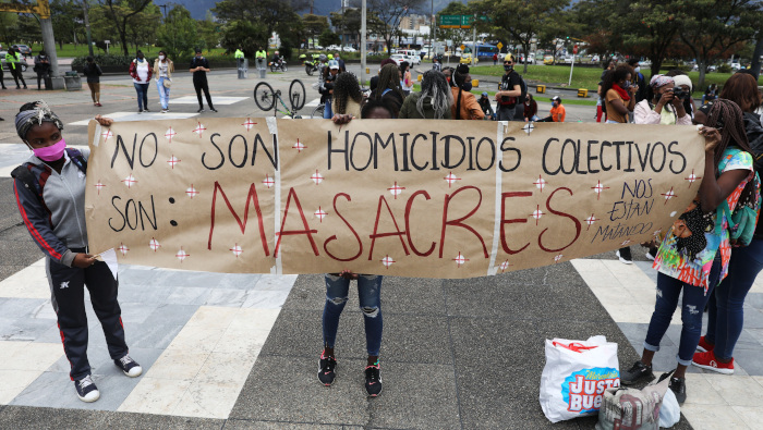 Jóvenes sostienen una pancarta de protesta durante una manifestación contra las masacres efectuada en agosto en Bogotá.
