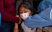 A girl gets a COVID-19 vaccine, Honduras, 2021.