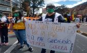 The banner reads, "Our struggle is for peace and the bad government announces war," Bogota, Colombia, 2021. 