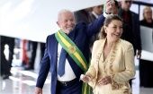 Luiz Inacio Lula da Silva (L), who is wearing the presidential sash, greets his supporters in Brasilia, Brazil, Jan. 1, 2023.