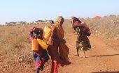 Women carrying water make their way to Baidoa camp in Somalia, Jan. 21, 2023.
