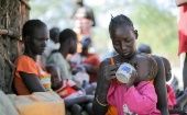 People receive food aid in Sudan, 2023.