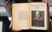A teacher shows a Shakespeare book.
