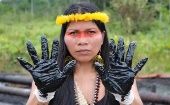An Indigenous woman protesting against oil pollution in the Amazon, 2023.