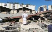 Priest observes the rubble of the Church, Madero city, Mexico, Oct. 2, 2023.
