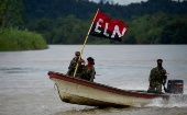 ELN members navigate a Colombian river, 2024.