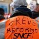 A railroad worker wears a vest that reads: SNFC Reform Strike.