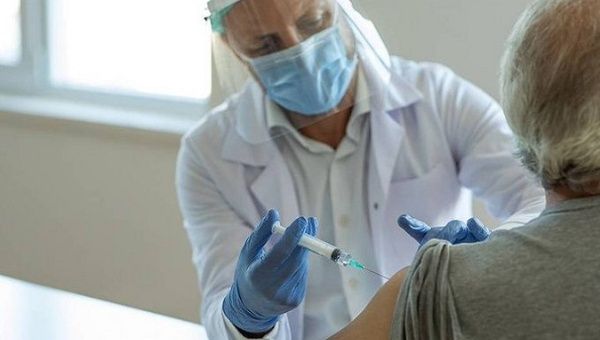 Health worker vaccinates a citizen with Sputnik V in Bolivia, Feb. 11, 2021.